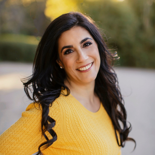 Female with yellow shirt smiling