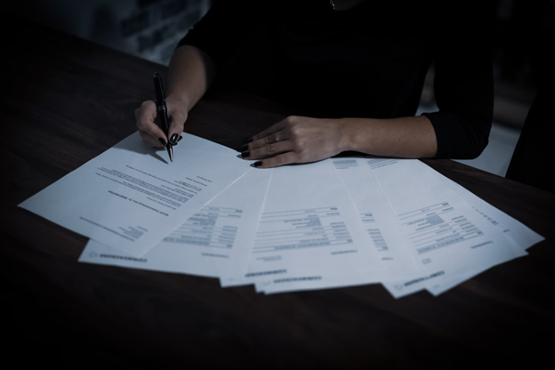 A person writing on a paper