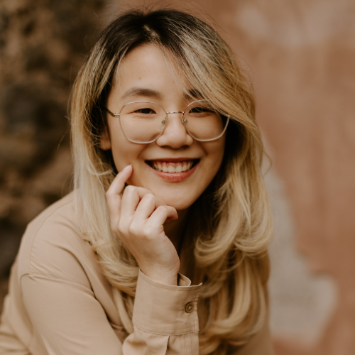 Female with hand to chin smiling