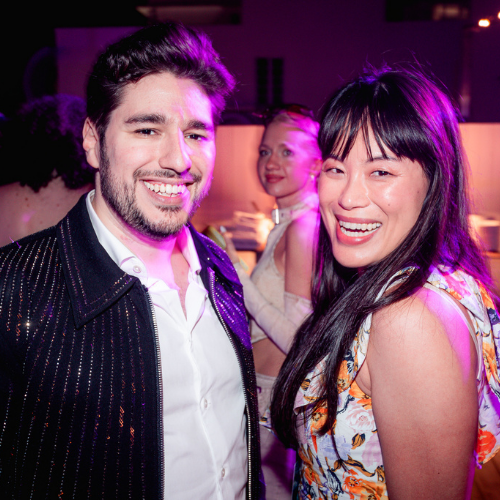 Male in black jacket and white shirt. Female in floral dress with black hair